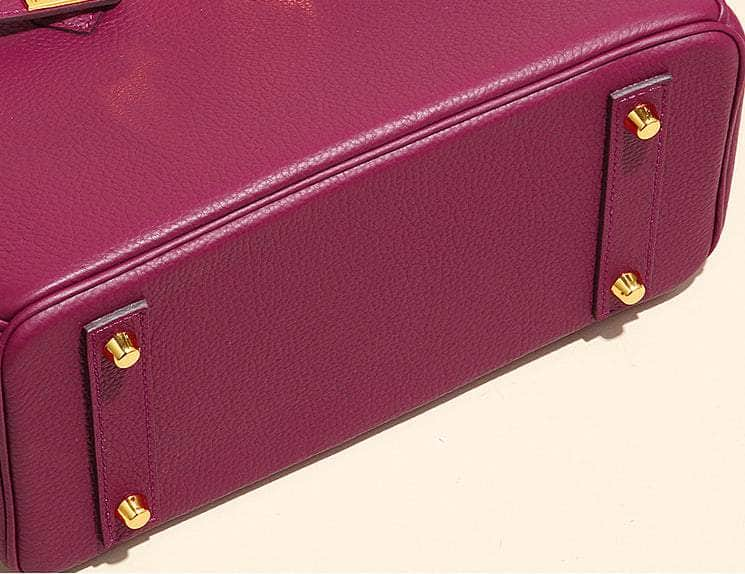 Chic Bordeaux Handbag Embellished with Gleaming Gold Features