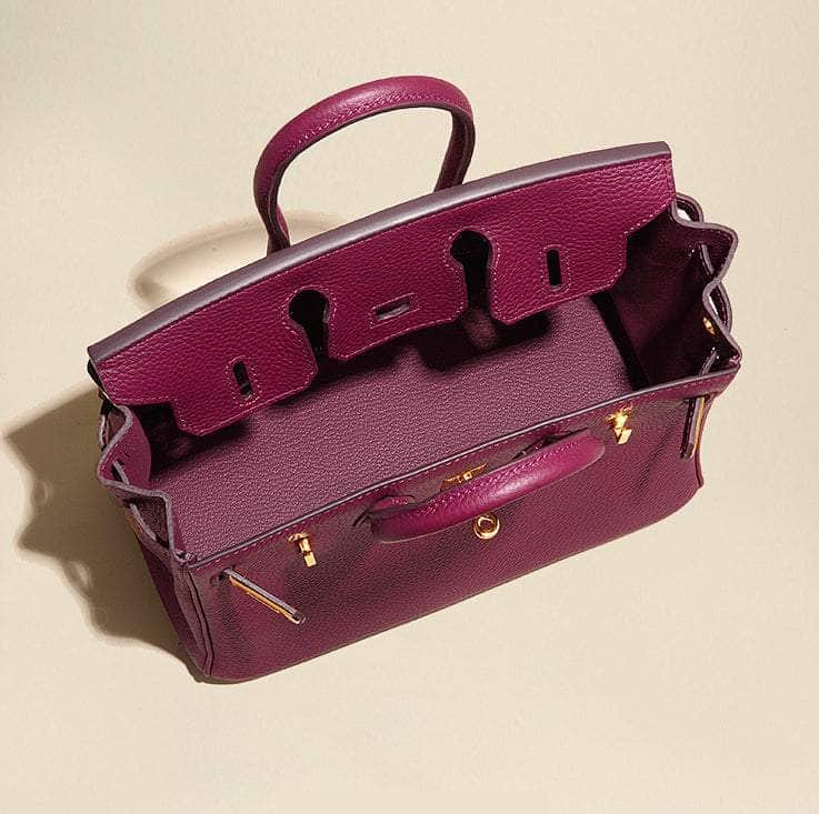 Chic Bordeaux Handbag Embellished with Gleaming Gold Features