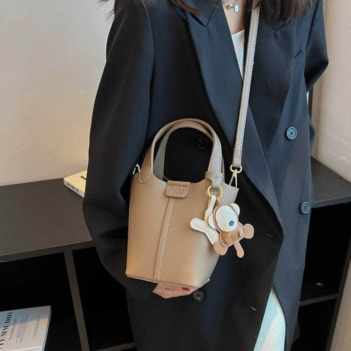 Sleek Crossbody Bucket Bag with Bear Charm