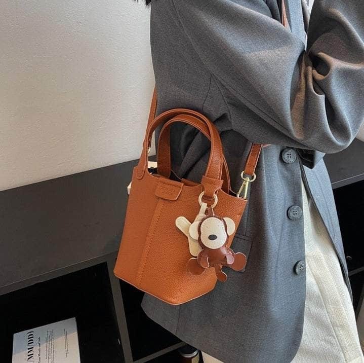 Sleek Crossbody Bucket Bag with Bear Charm