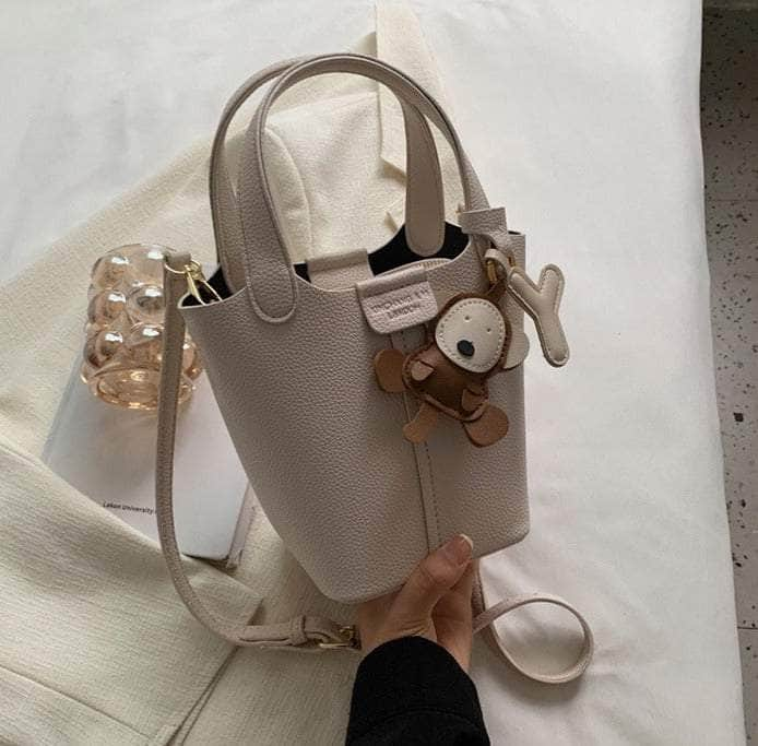 Sleek Crossbody Bucket Bag with Bear Charm Ivory